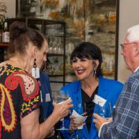 President Philomena Mantella chatting with two event attendees